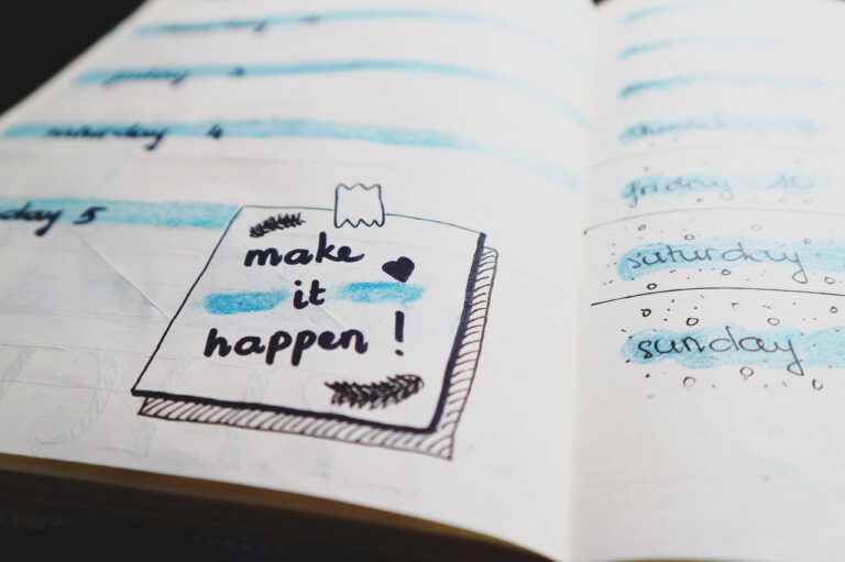 Notebook, with handwritten note that says, "Make it happen!"
