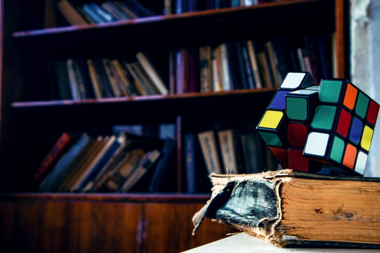Old book, rubik's cube on top of it.